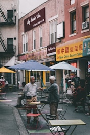 A lively street scene capturing diverse people engaged in animated conversation.