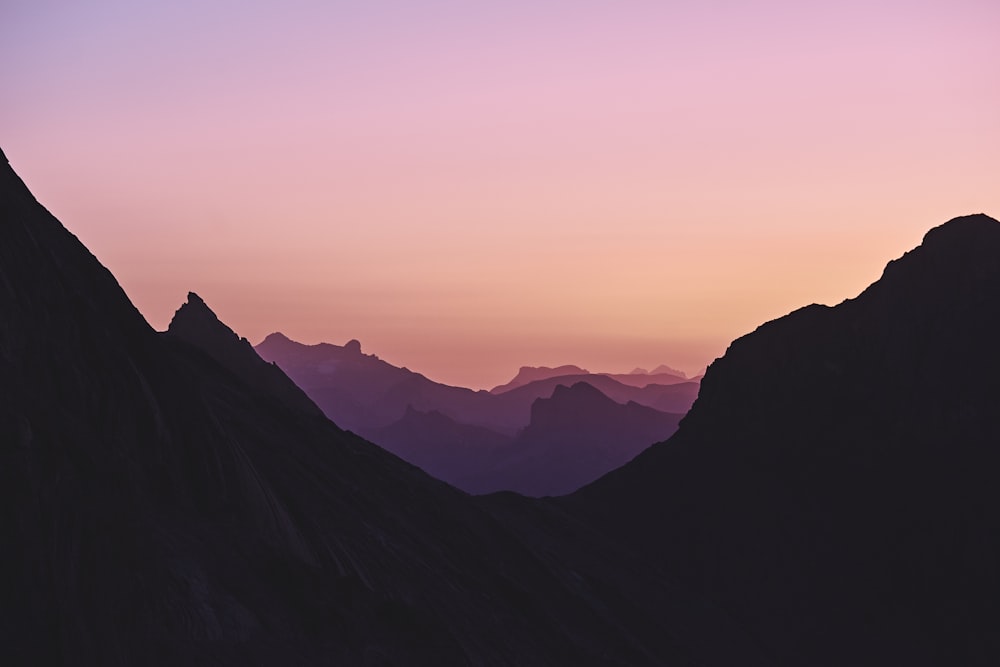 the silhouette of a mountain range at sunset