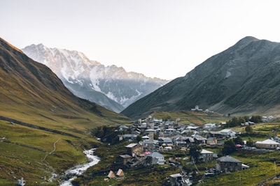 aerial photography of houses beside rocky mountains during daytime georgia teams background