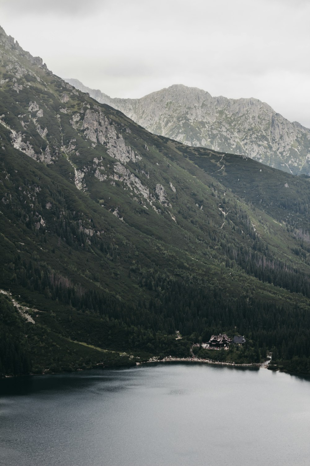 lake beside mountain during daytime