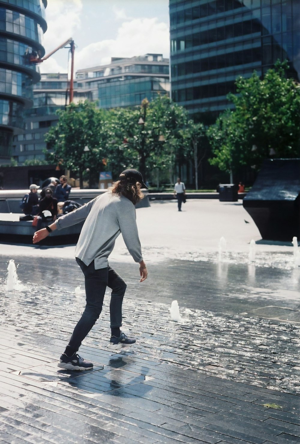 person wearing gray long-sleeved shirt crossing street