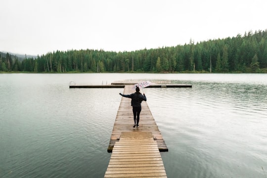woman standing on dock in Lost Lake Canada