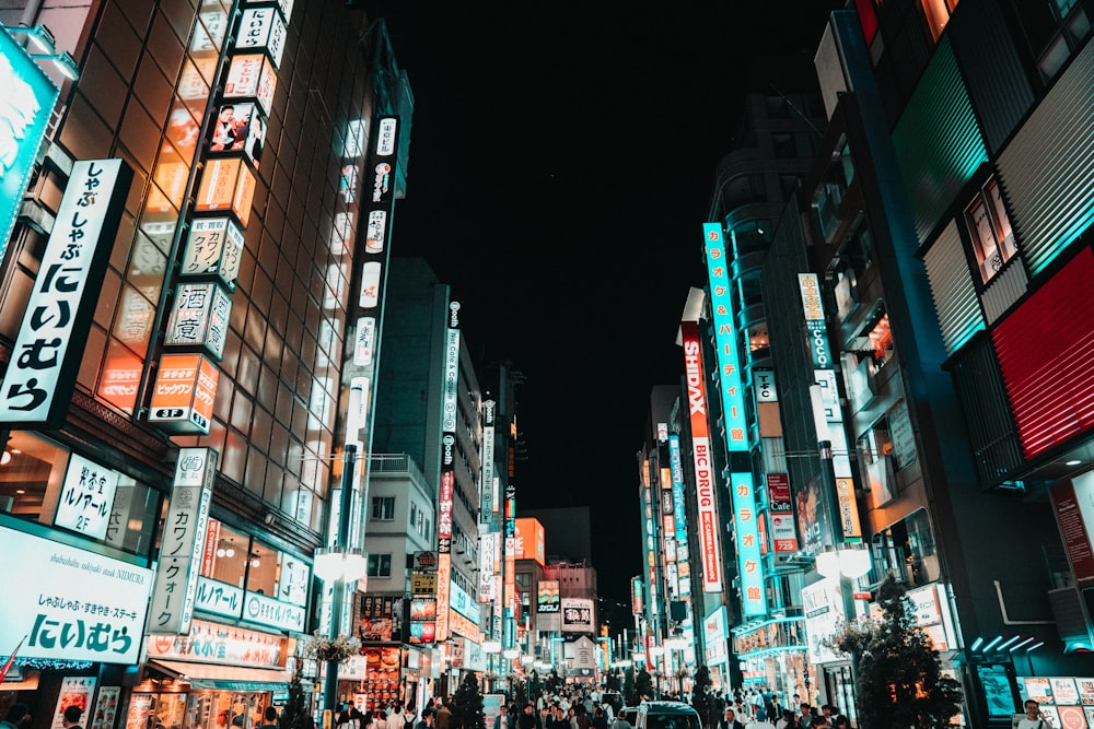 crowd of people in the streets of a city during nighttime