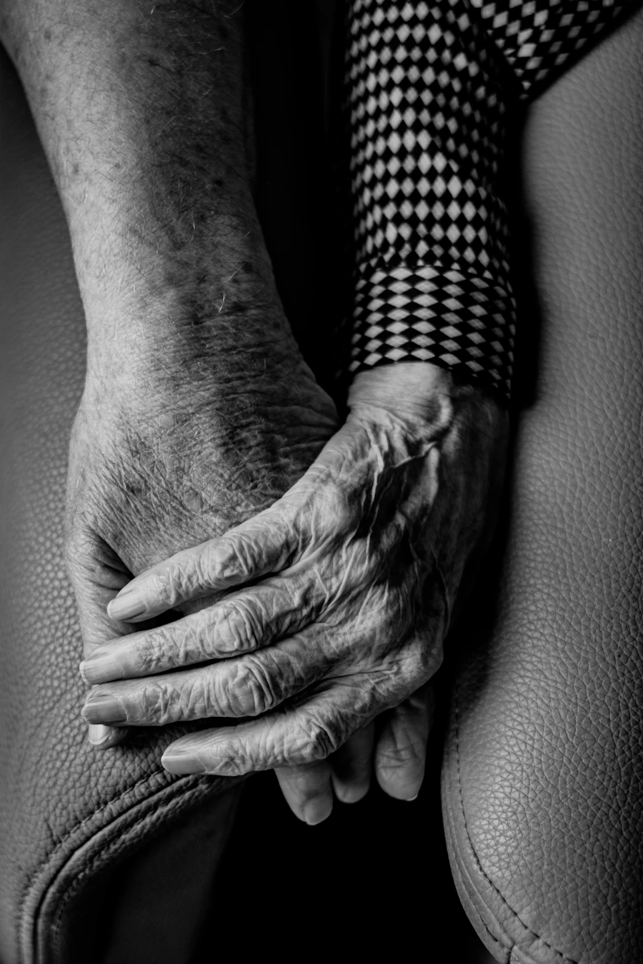 Close up of a caregiver's hands offering support