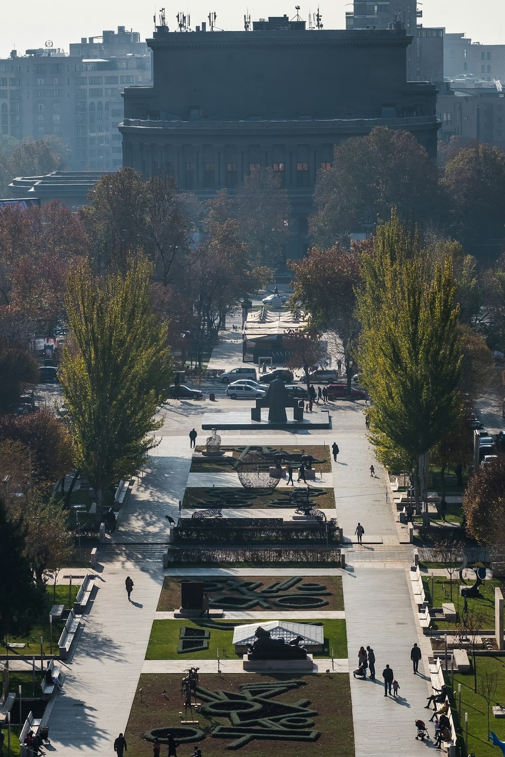 people walking in park near high-rise buildings during daytime