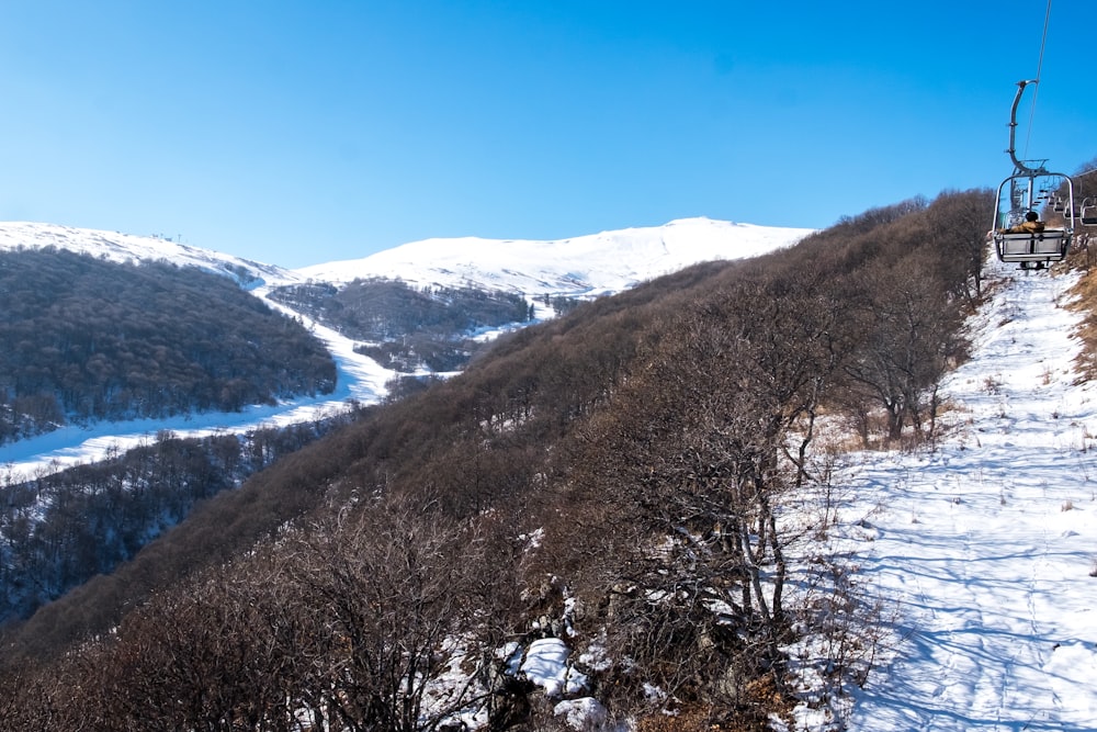 aerial photography of field covered with snow under blue and white skies during daytime