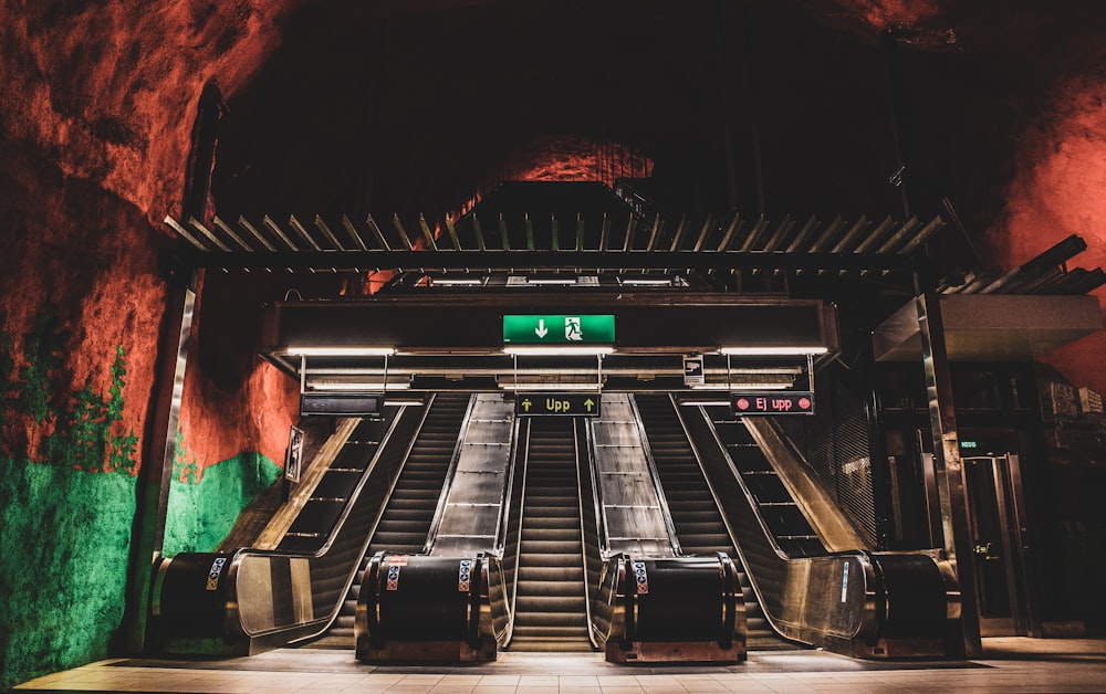 an escalator in a subway station with two sets of luggage