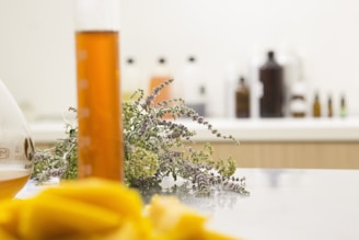 a bottle of orange liquid sitting on top of a table