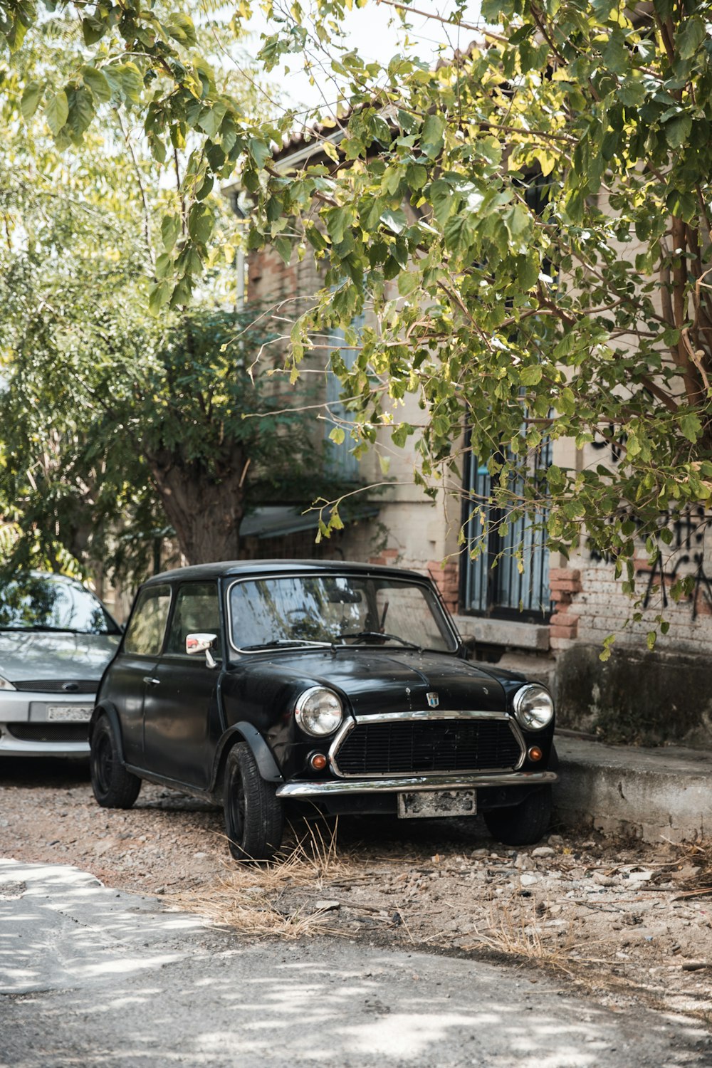 black car parked beside white building