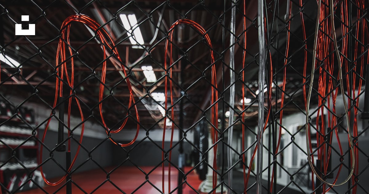 Bunch of white and red jumping ropes hanging on chain link gate photo ...