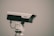 A surveillance camera mounted on a white stand, positioned against a plain background. The camera is branded with the logo 'Dahua' and appears to be pointed to the right.