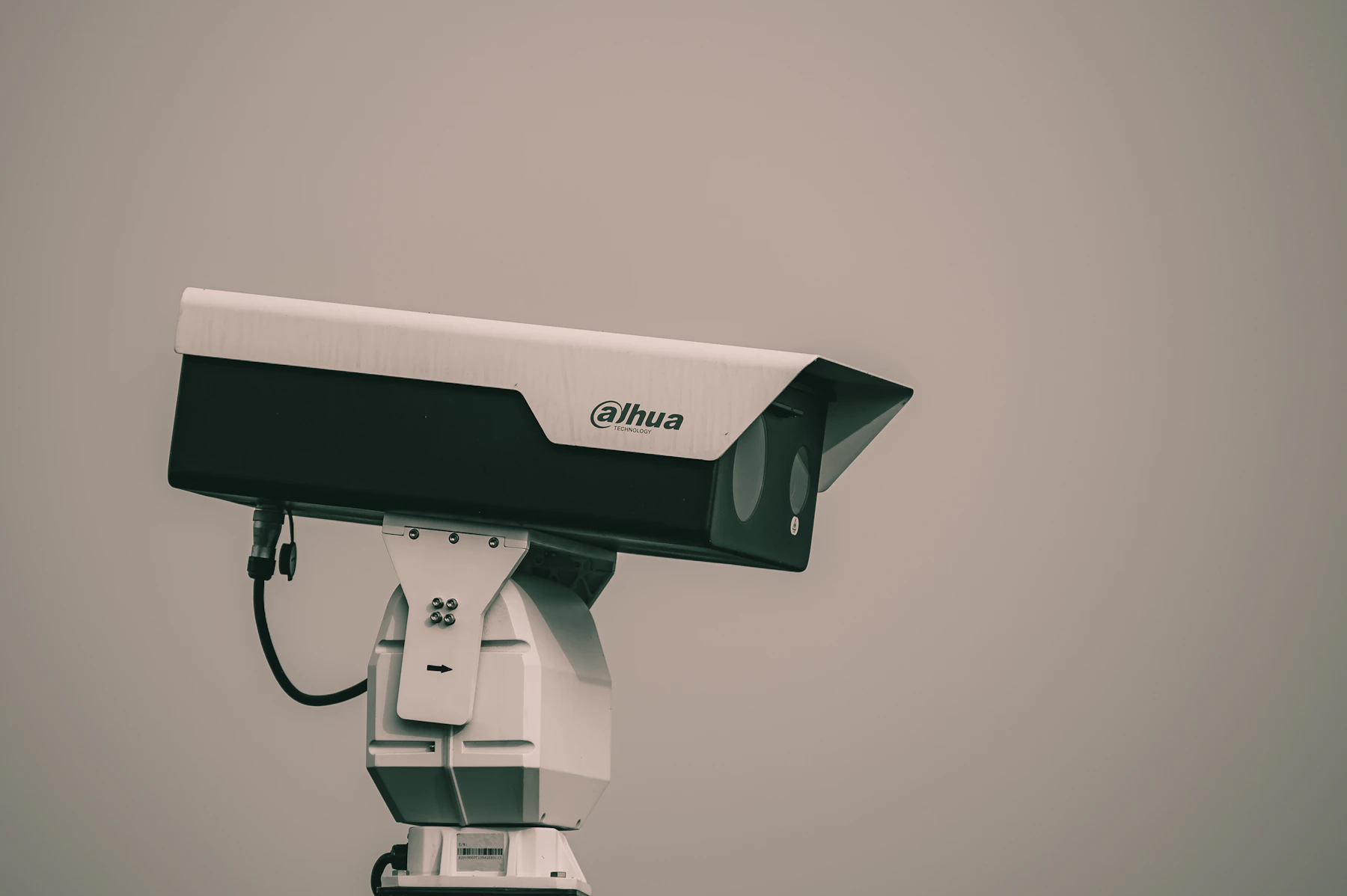A Security Camera Isolated Against A Pale Background