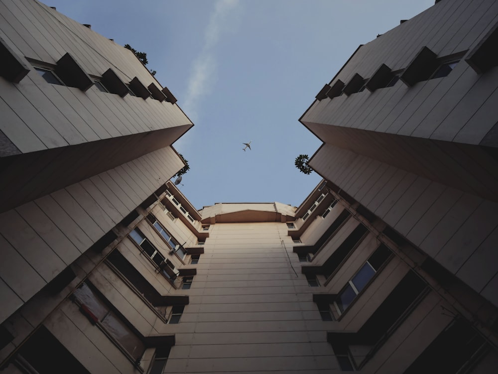 airplane flying on top of building