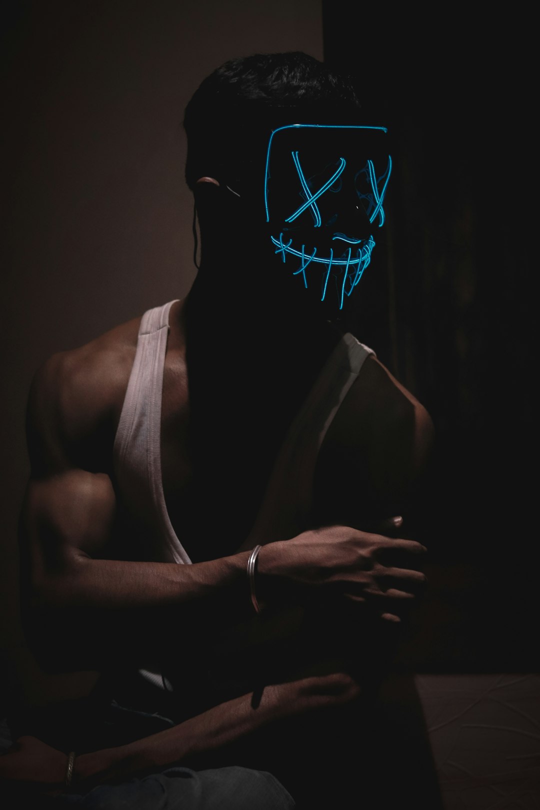 man in white tank top wearing mask