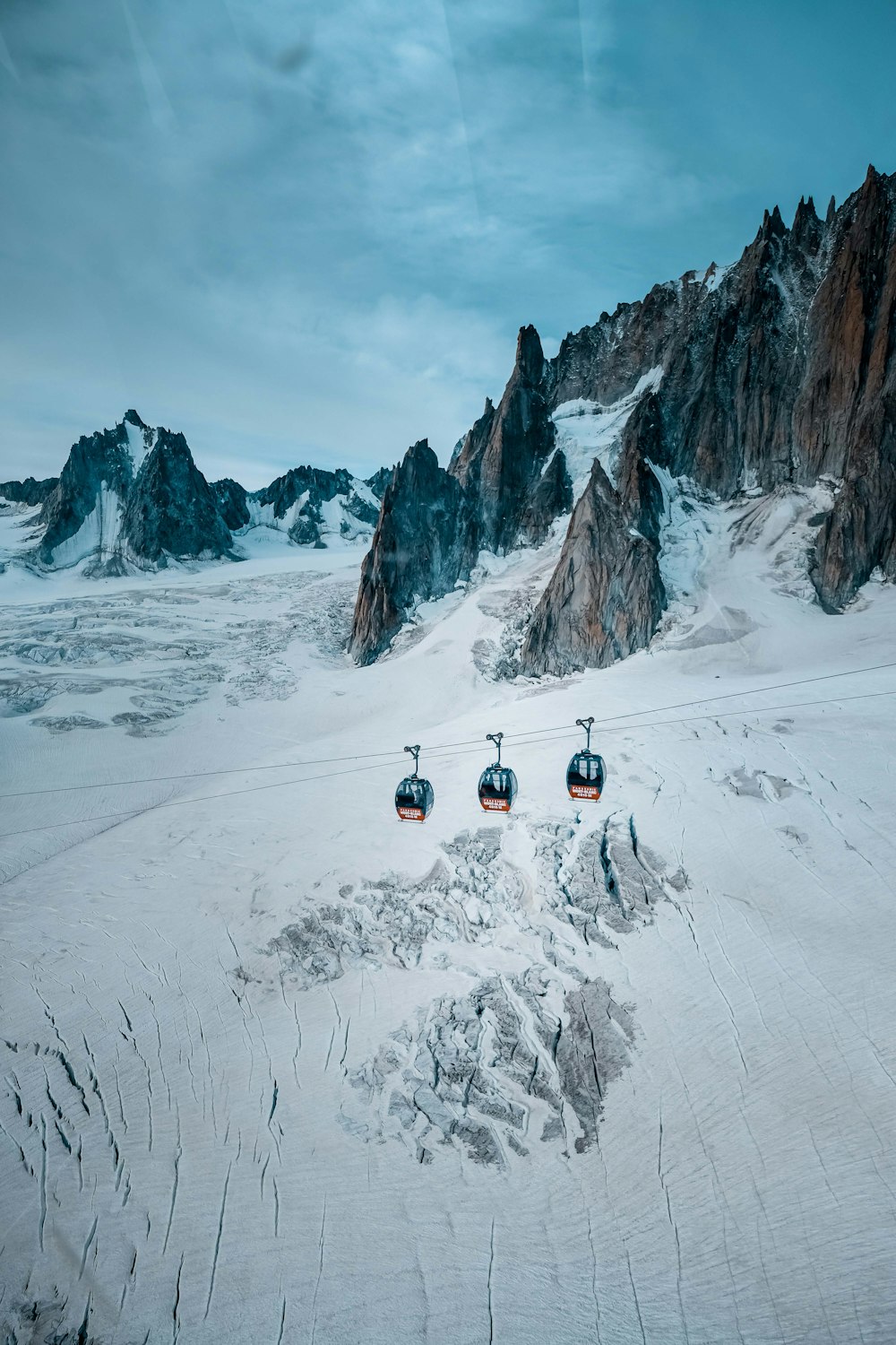 aerial photography of cable cars under clear blue sky