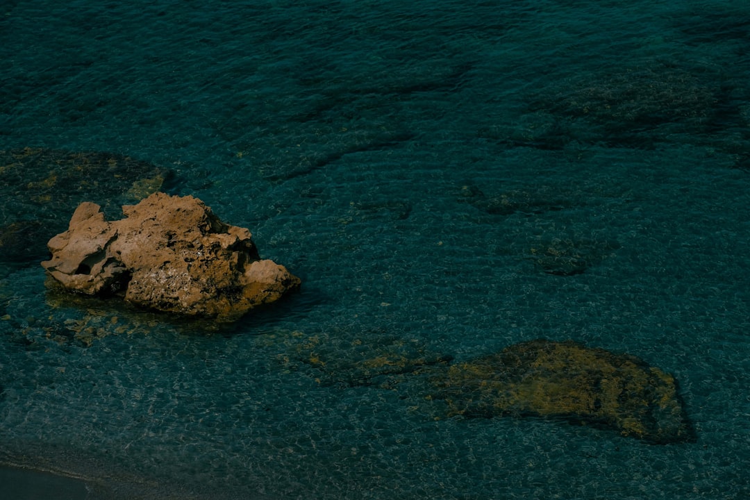 brown rock in ocean