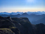 A panoramic view of layered mountain ridges fading into the horizon.