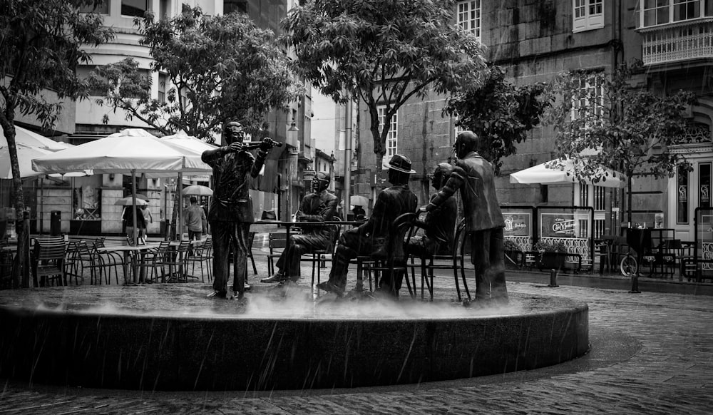 people sitting on bench statue