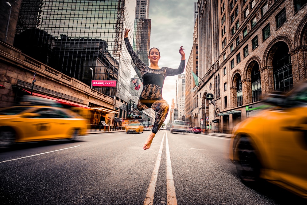 woman jumping on road