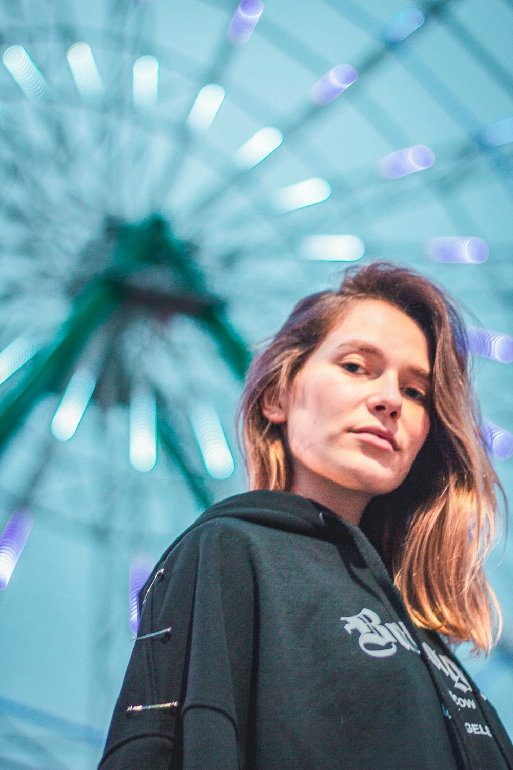 woman standing front of Ferris wheel