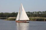 A group sailing quietly on calm waters during a low-carbon footprint tour in Sicily.
