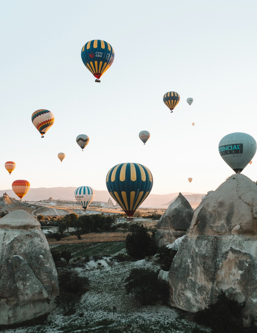 hot air balloons above rocks