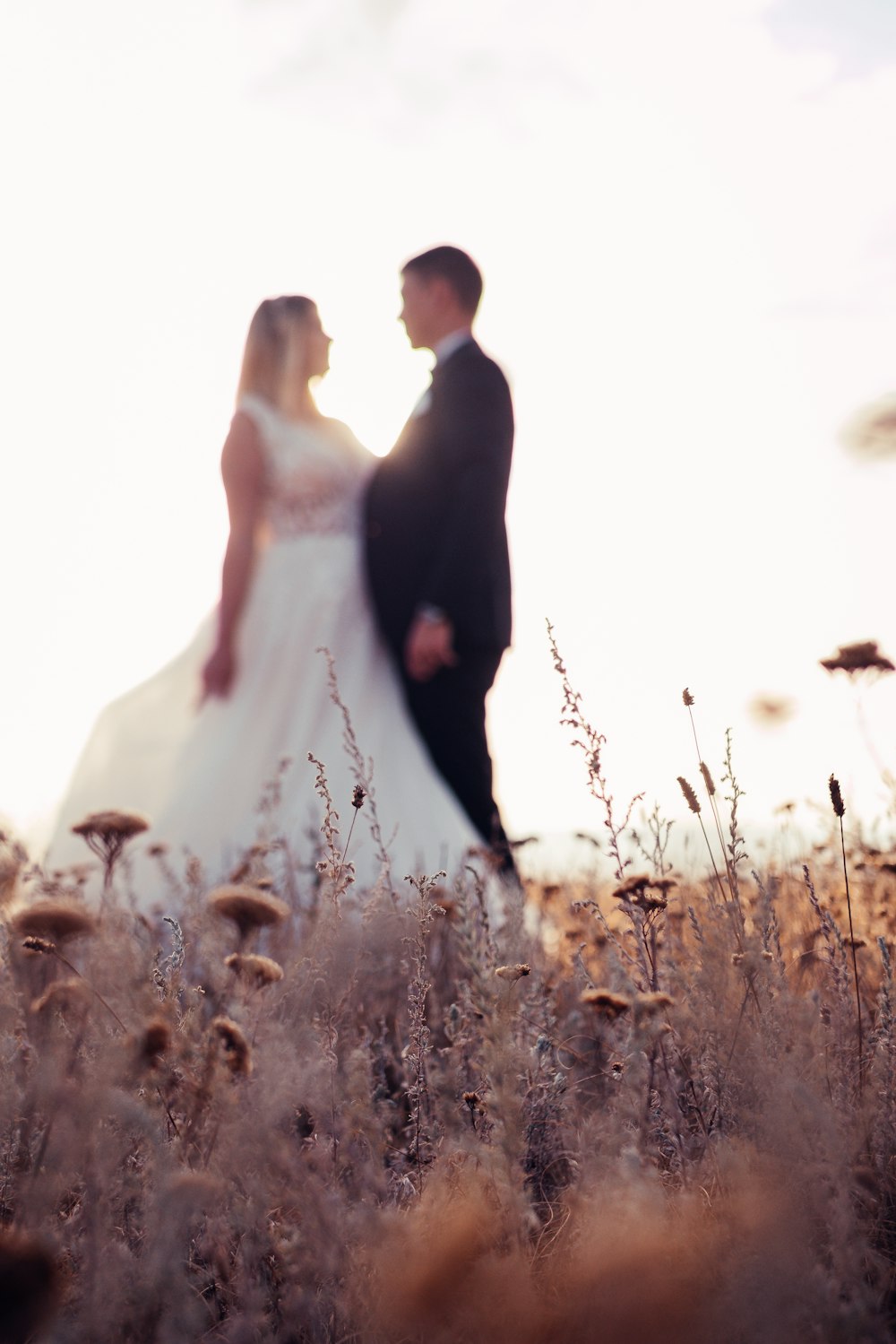 bride and groom standing on field