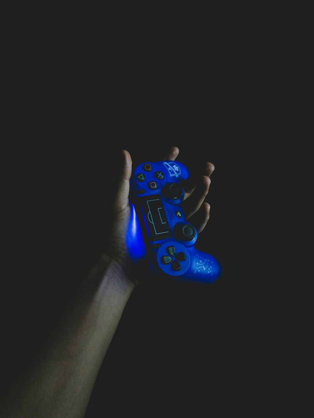 person holding blue cordless controller