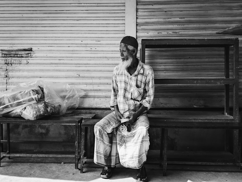 grayscale photography of sitting man wearing dress shirt