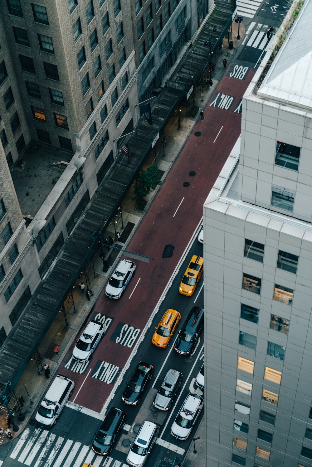 aerial photography of different vehicles on road near buildings during daytime