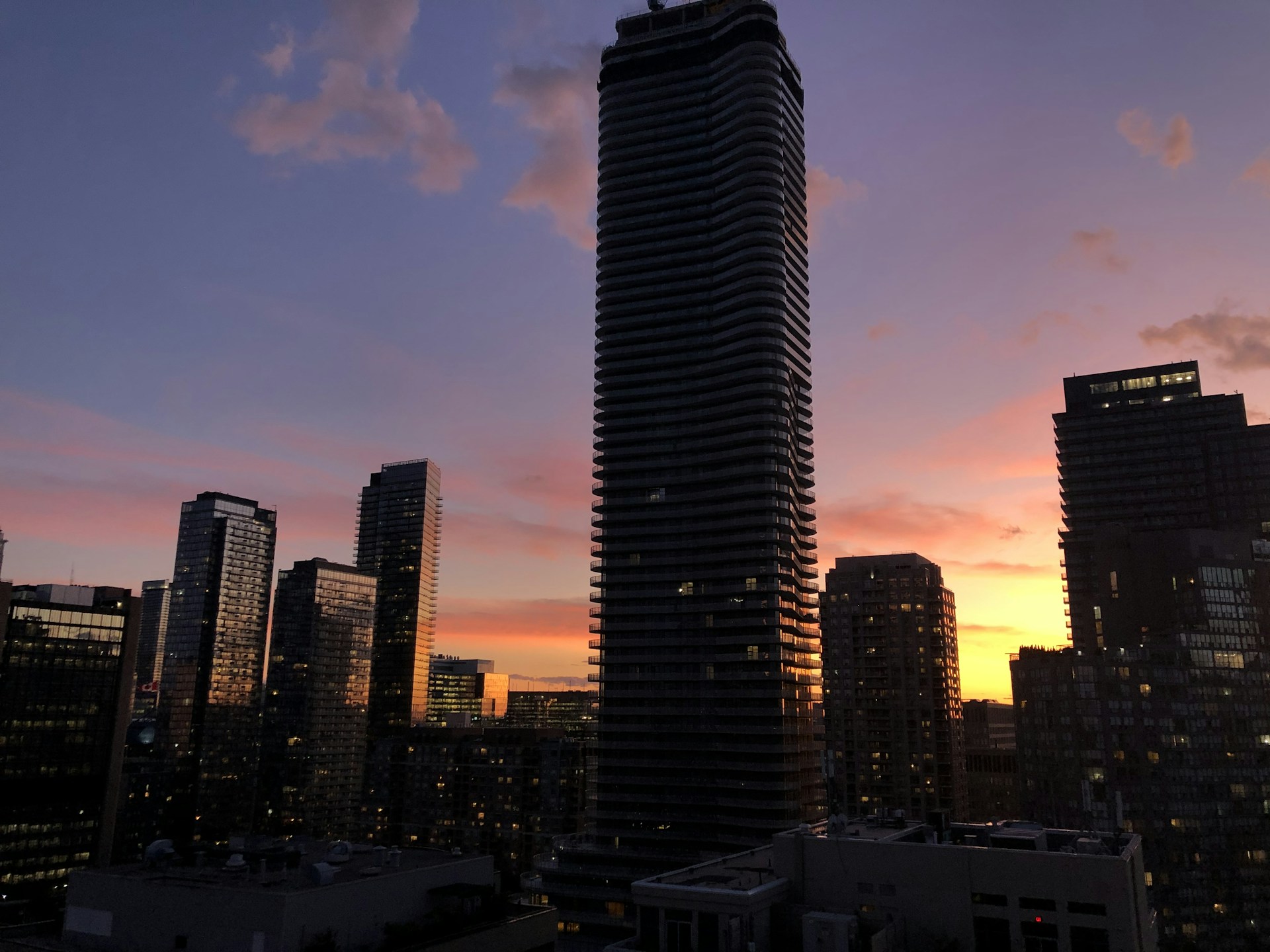 woman wearing yellow long-sleeved dress under white clouds and blue sky during daytime