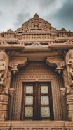 The temple’s beautifully carved wooden doors showcasing intricate craftsmanship