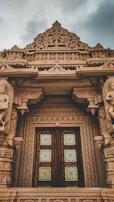 Close-up of intricate traditional carvings on the temple’s wooden doors.