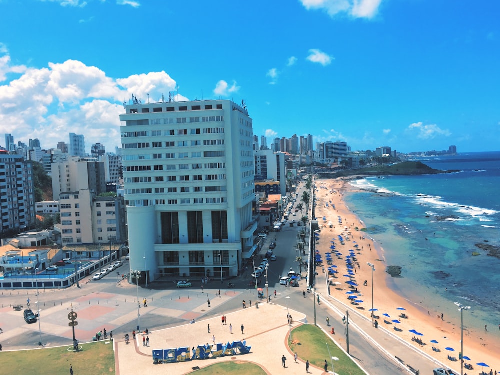 people on shore beside building during daytime