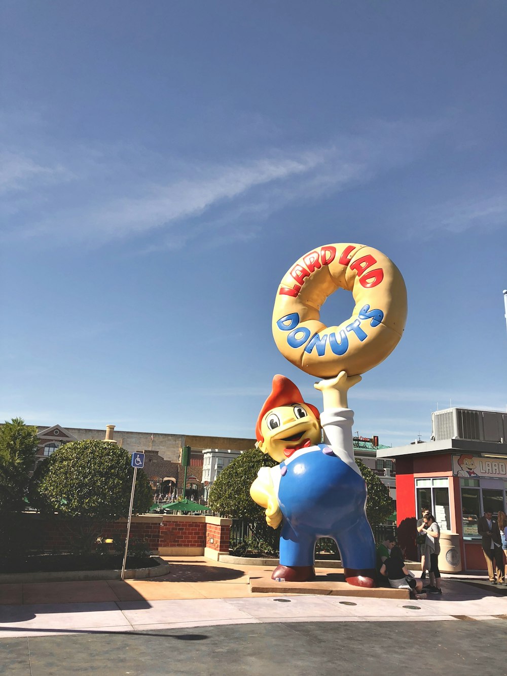 blue and white character carrying doughnut statue