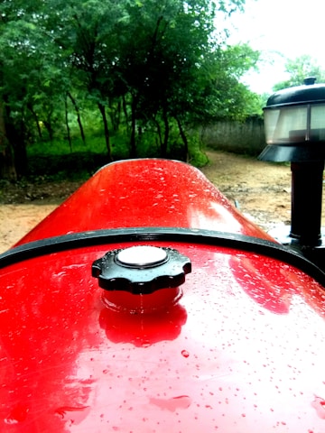 Close-up of a sparkling clean tractor after a thorough wash in a rural setting.