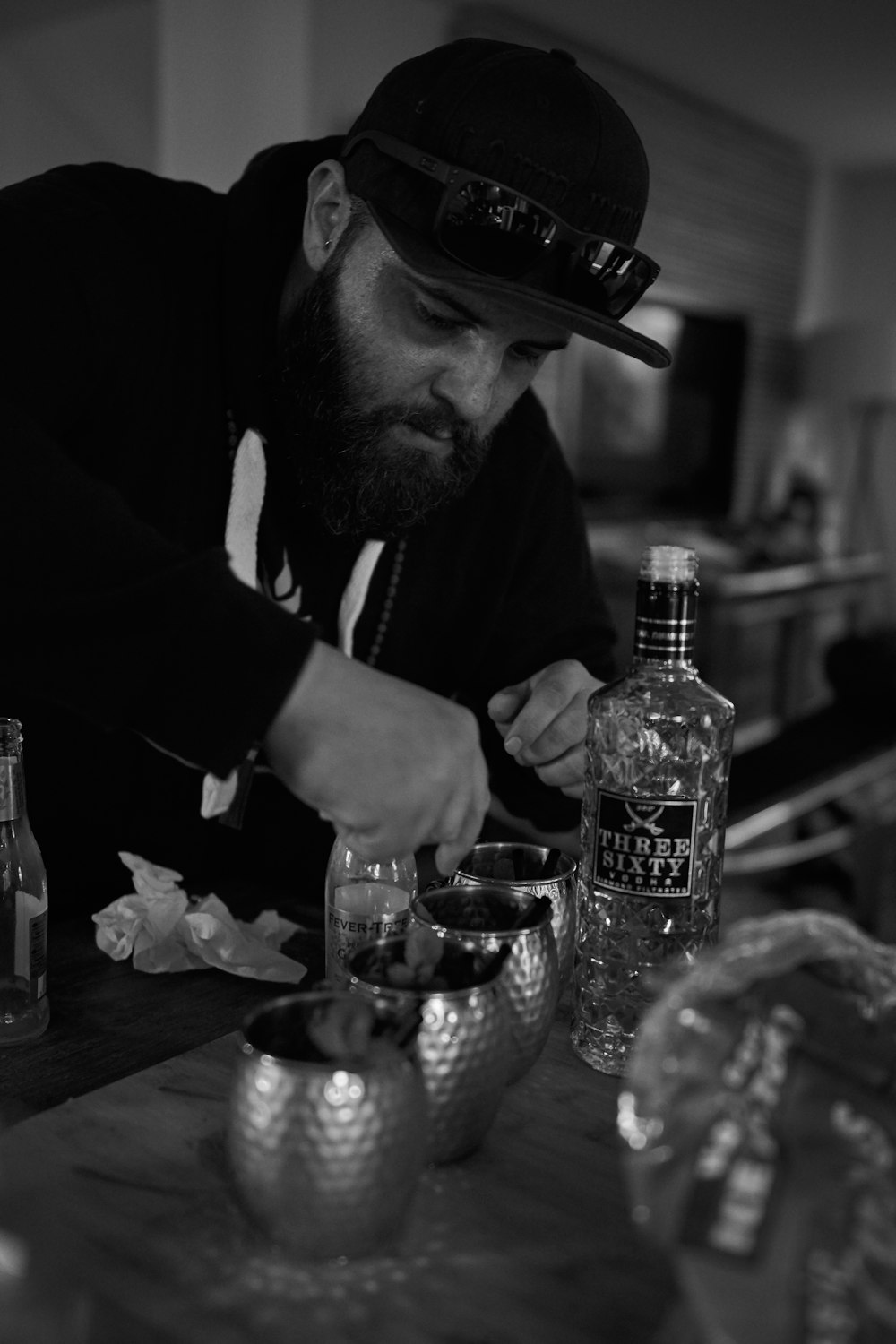 grayscale photography of man mixing drinks