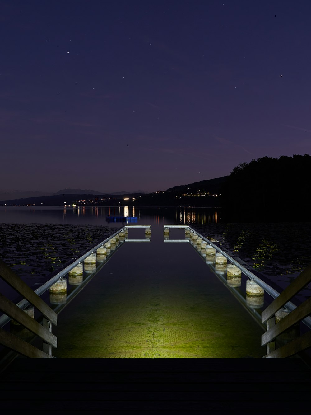 stairs beside water at night