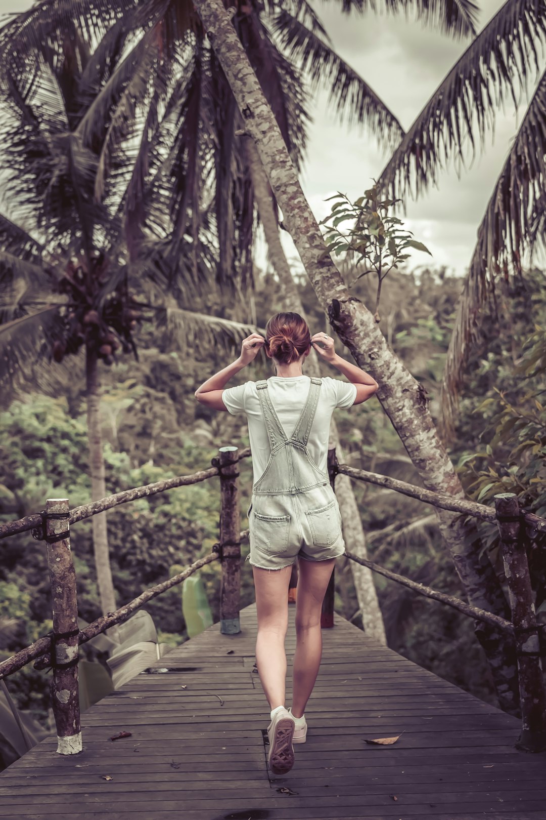 woman standing on brown wooden platform