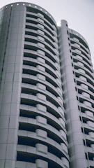 A sleek modern residential building developed by Sekara Living, showcasing clean lines and minimalist design.