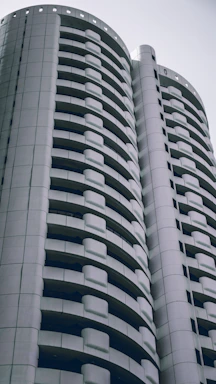 Contemporary condo building with sleek design and balconies.
