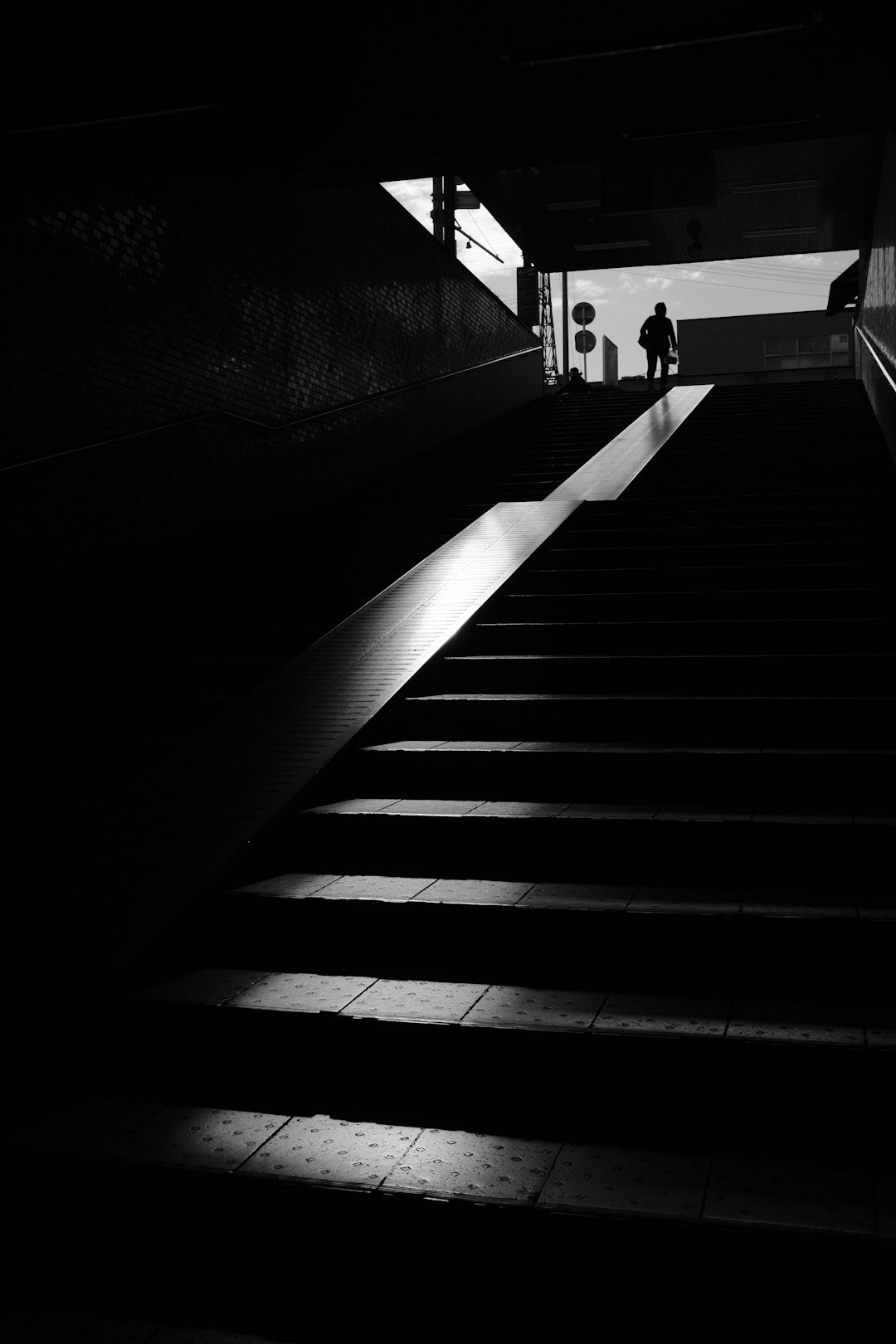 silhouette of person walking upstairs