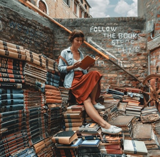 woman wearing denim jacket reading book