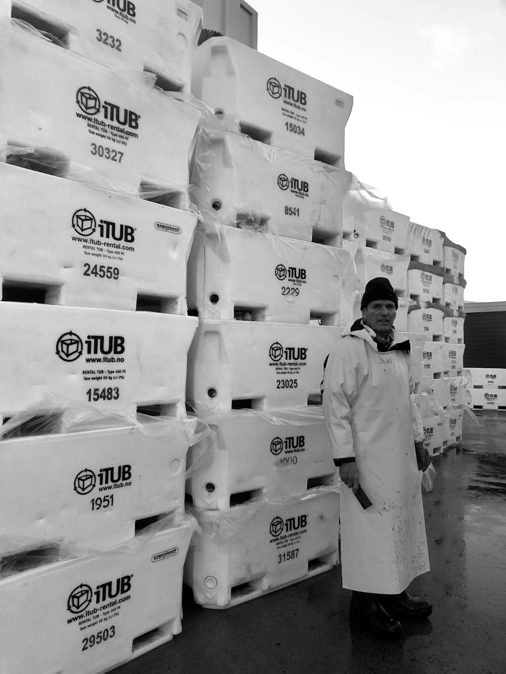man standing in front of pile of boxes