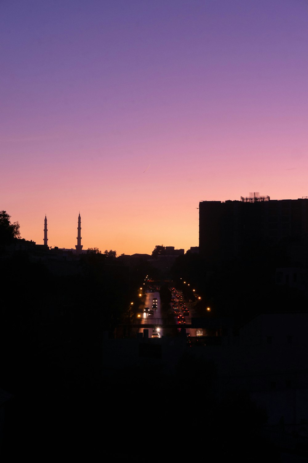 a view of a city street at dusk