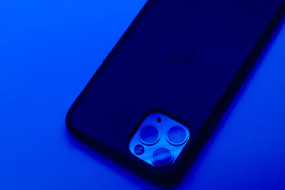 Close-up of a sleek smartphone with neon blue highlights on a dark background.