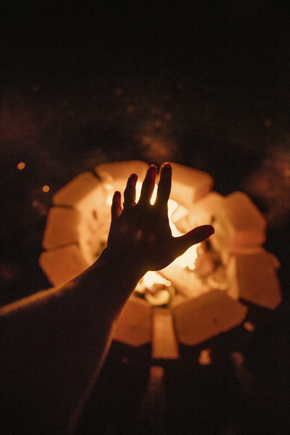 person putting left hand near bonfire