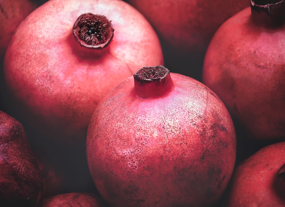 a bunch of pomegranates that are sitting together