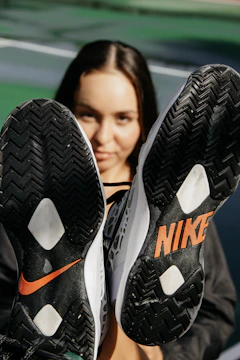 Close-up of sturdy TPEE outsoles showcasing tread patterns and green accents.