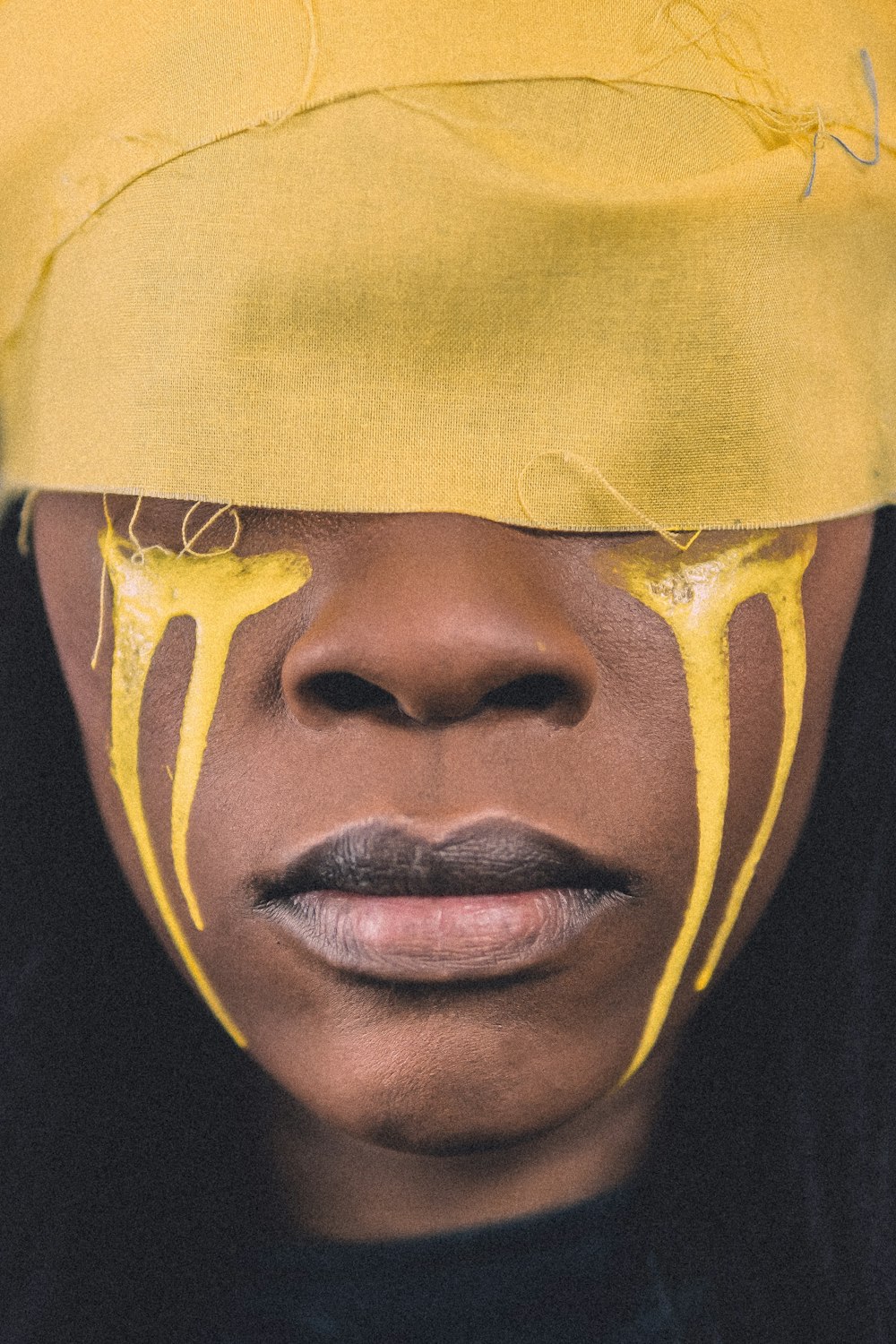 woman' face with yellow paint